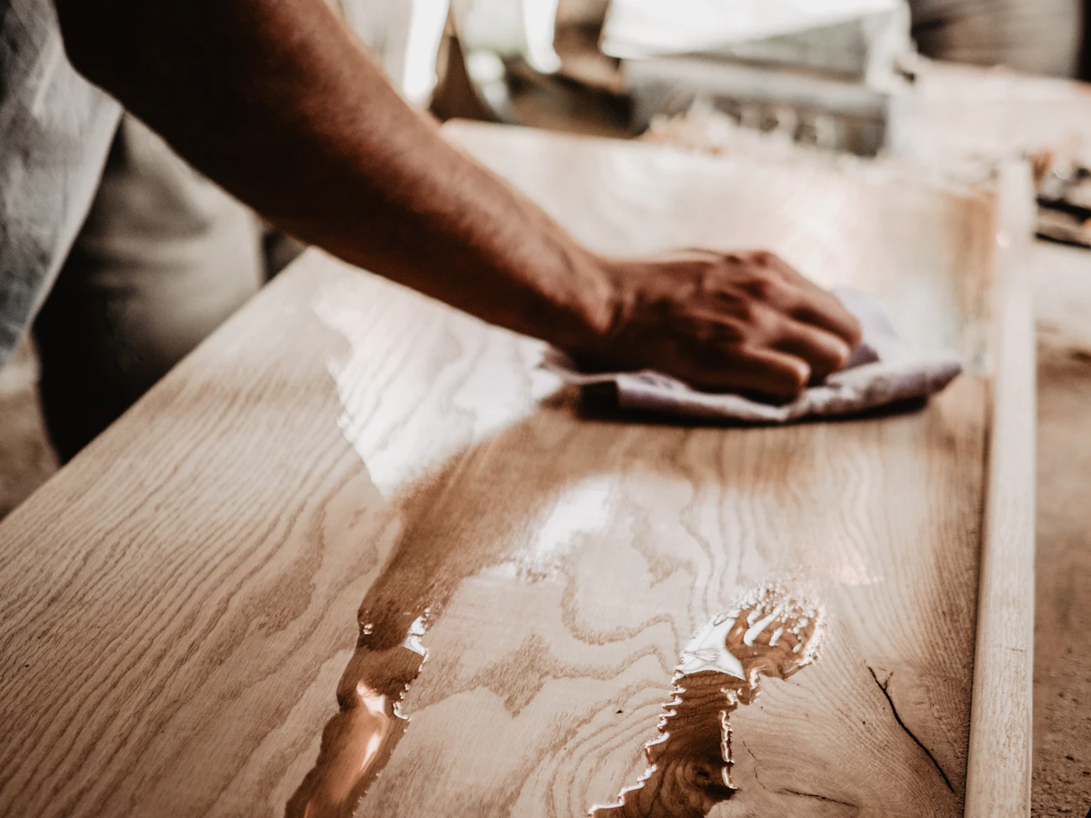 Hands carefully wiping a household surface
